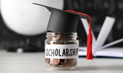 Coin jar labelled scholarship wearing a graduation cap