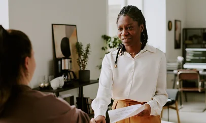 Employer handing a document to a team member